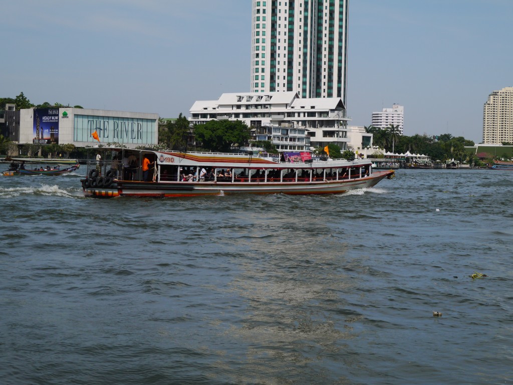 An Express Boat Traveling Along The Chao Phraya River In Bangkok