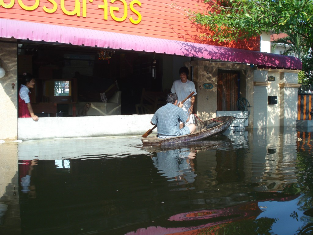 man-in-boat-during-bangkok-floods Man In Boat