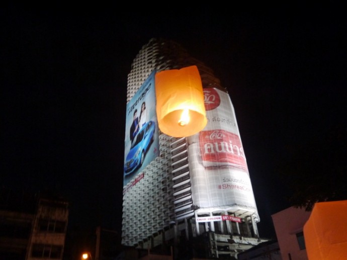 A Lone Lantern Floats In Front of The Abandoned Sathorn Unique Tower