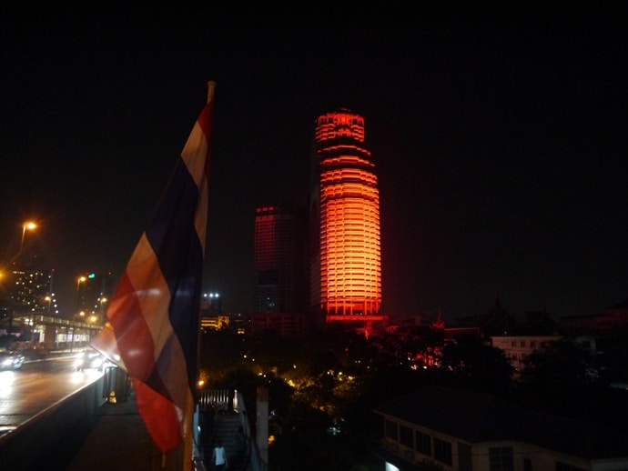 View From Taksin Bridge, With Thai Flagm And Traffic Rushing Passed