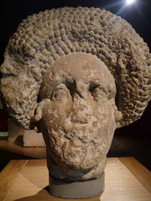 The Stone Head Of A Lady At Roman Baths