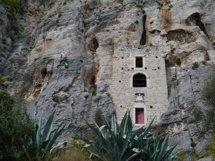 A climber next to the Hermitage Caves in Split, Croatia